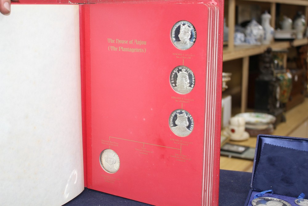 A set of the Kings and Queens of England sterling silver proof medallions, housed in original album and three other cased sets